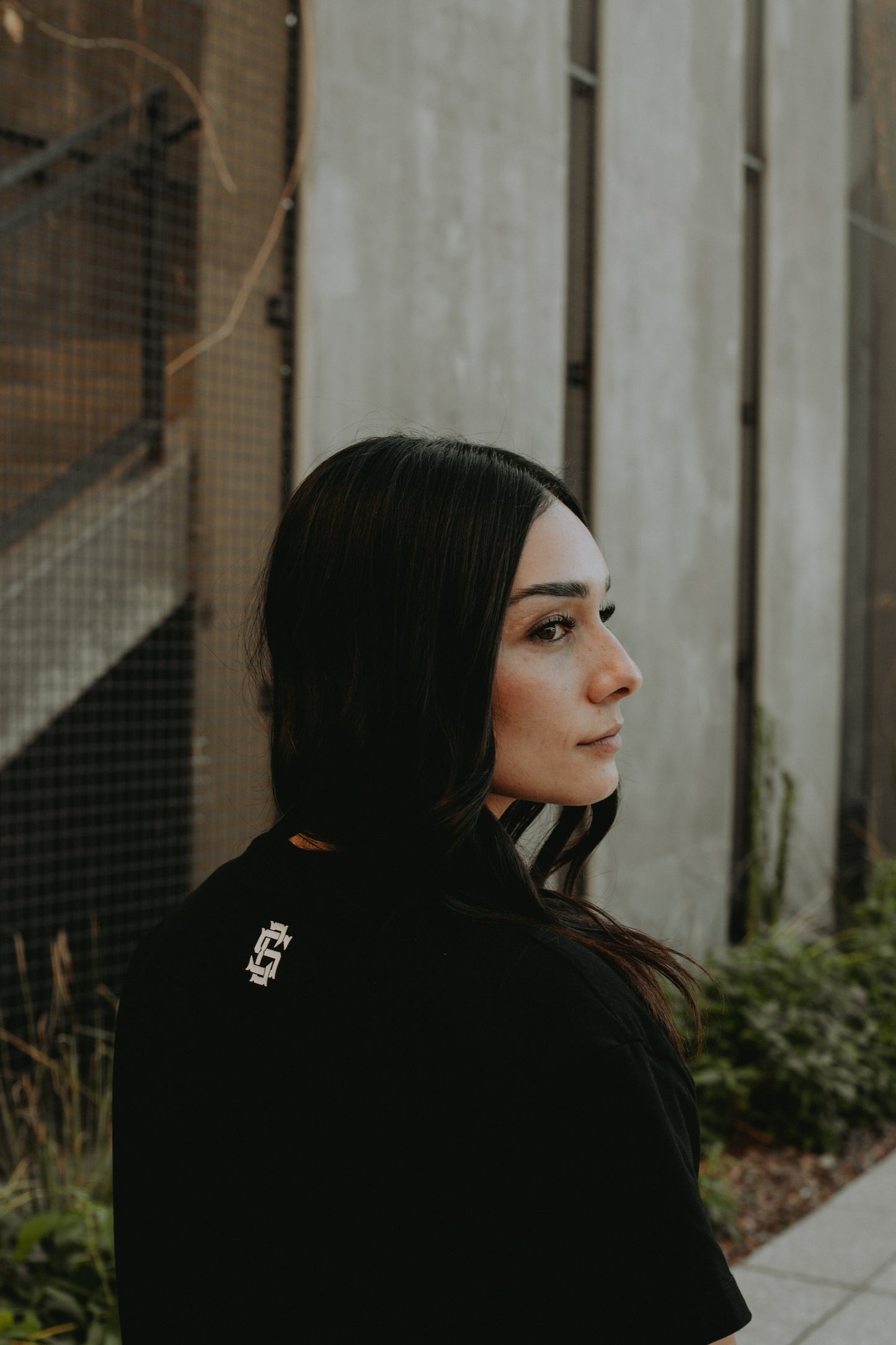 Back of the Brushed Black Minimalist Cropped Tee with the CS logo on the back neckline in screen print. 