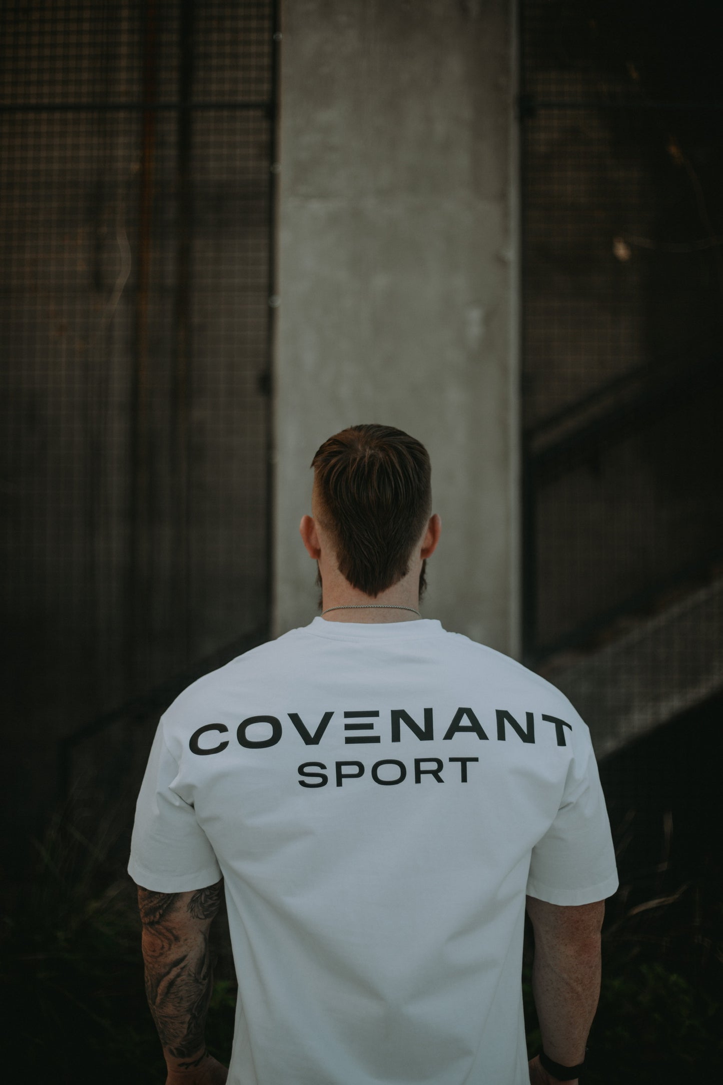 Back view of the Brushed White Covenant Sport Tee showing the "Covenant Sport" logo from shoulder to shoulder on the back of the shirt. 