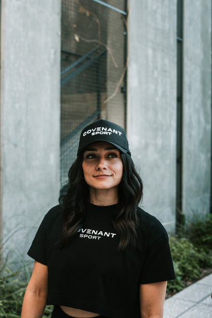 Female model wearing the Original Trucker hat forwards and showing off the "Covenant Sport" branding on the front of the hat.