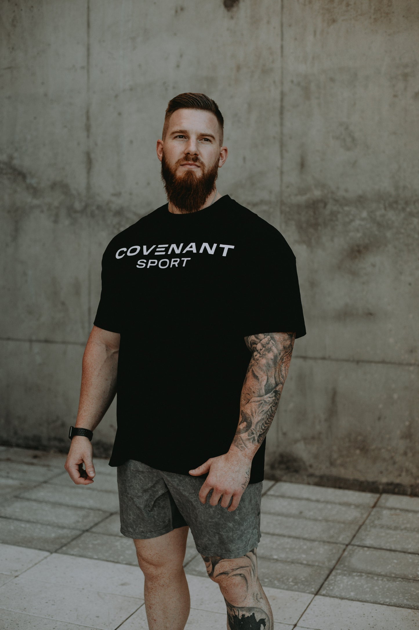 Brushed Black Covenant Sport Tee on model showing the length and fit of the oversized tee. 