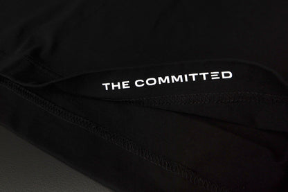 "The Committed" printed on the inside hem of each tee. 