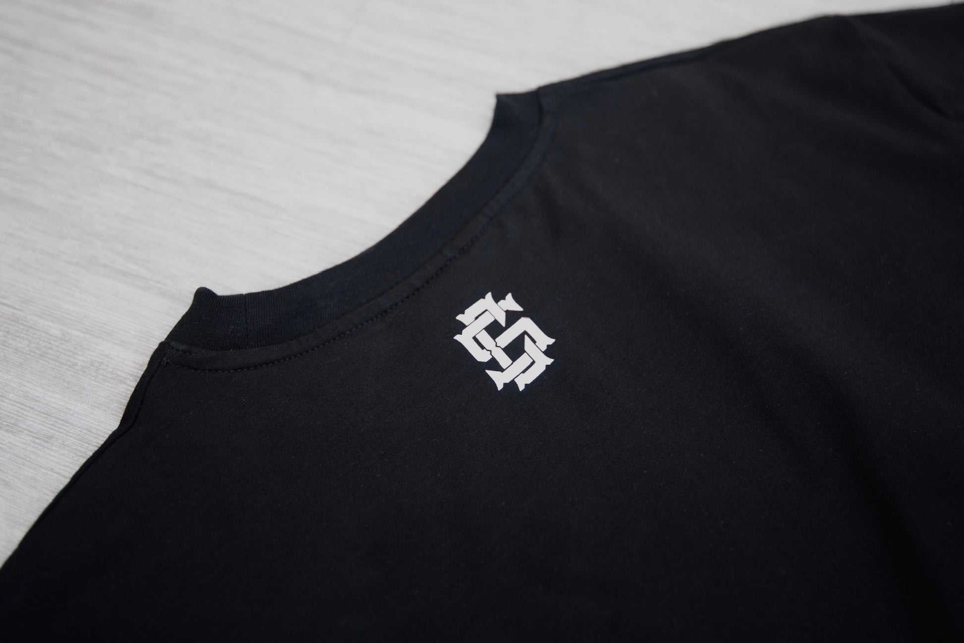 CS logo on the back neckline of the cropped tee. 